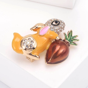 Close-up of a golden bunny brooch with shiny rhinestones and colorful enamel detailing