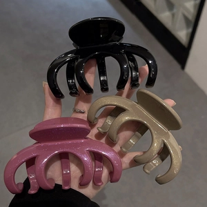 Three large matte black, pink, and beige hair claw clips for thick hair styling
