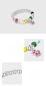 Detailed macro view of S925 sterling silver beads and colorful enamel flower pendant