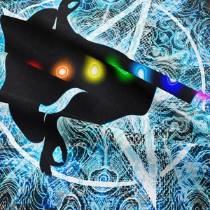 Detailed view of black tapestry fabric featuring glowing colorful gemstone prints