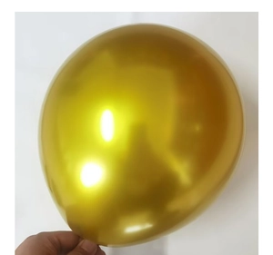 Detail of hand holding a 10-inch metallic gold balloon for New Year wedding party decor