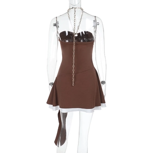 Detailed back view of brown halter dress with metallic chain and white hem detail