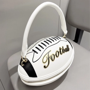 Detail of rugby-shaped white handbag with gold Football text and faux leather texture