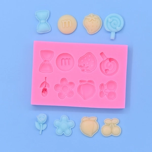 Pink silicone mold with 8 flower and fruit shapes for DIY cake and craft projects
