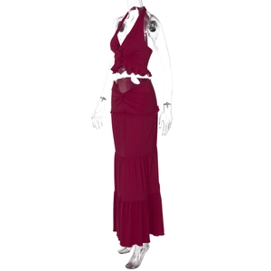 Detail of burgundy two-piece set with V-neck halter top and tiered maxi skirt