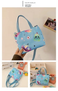 Detail of light blue canvas bag featuring colorful Halloween prints and dual handles