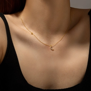 Elegant S925 sterling silver gold moon and star zircon pendant necklace worn by a model