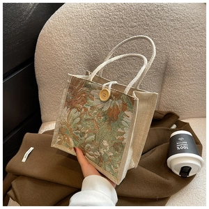 Close-up of floral linen tote bag with cotton rope handles and wooden button closure