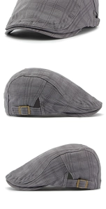 Detalle de hebilla metálica y textura de cuadros grises en gorra plana de algodón vintage