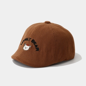 Detail of brown corduroy kids beret with embroidered lovely bear and logo text