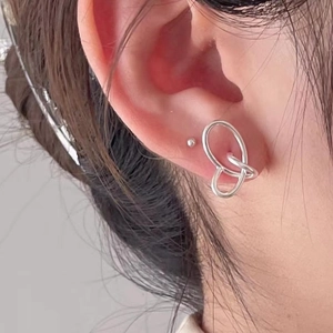 Minimalist 925 sterling silver woven twist stud earrings worn on a female model