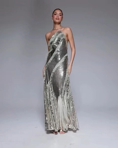 Detail of silver sequin evening gown featuring a halter neck and shimmering long tassel hem