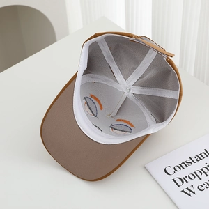 Detailed interior of the brown cotton baseball cap showing reinforced seams and stitching