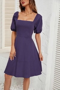 Detailed view of the purple square neck dress with puff sleeves and woven fabric texture