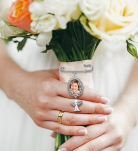 Silver memorial wedding bouquet pin with photo frame and angel charm detail on flowers