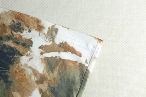 Close-up of double stitching and marble print on casual earth-toned sleeveless dress