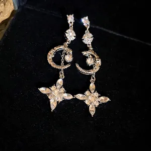 Elegant silver star and crescent moon dangle earrings with sparkling rhinestones