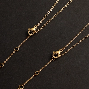 Detailed macro view of 14K gold-plated stainless steel chain with lobster clasp for jewelry