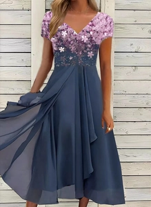 Detail view of purple floral print bodice and grey-blue chiffon skirt on a V-neck dress