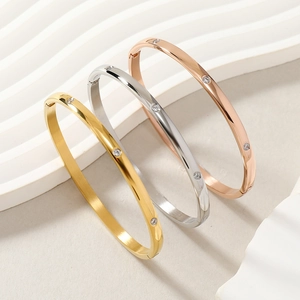 Detailed view of three-piece titanium steel hinge bracelets in gold, silver, and rose gold