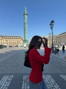 Red slim fit blazer with black bow details styled in Paris Place Vendôme street shot