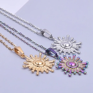 Detailed view of three sun-shaped necklaces in silver, gold, and rainbow 18k plated finish