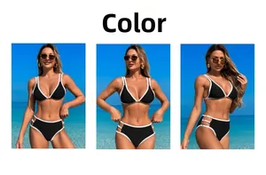 Detail of high-waisted black bikini with white trim and side cutout metal ring accents