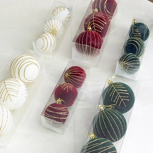 8cm flocked Christmas balls in red, green and white with gold glitter leaf patterns