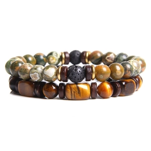 Macro shot of tiger eye and lava stone beads set with natural textures and metallic spacers