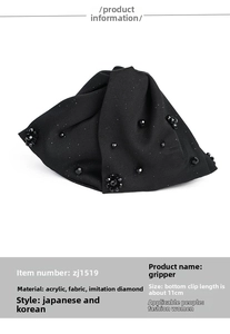 Close-up of black satin double bow hair claw clip with crystal bead details