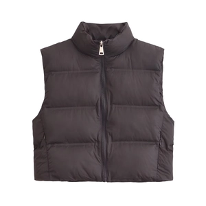 Detail of black puffer vest featuring a stand collar and horizontal quilted padding