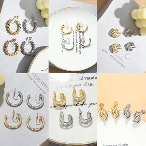 Close-up of minimalist irregular gold and silver ear cuffs in various geometric designs