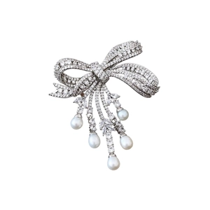 Elegant silver bow brooch with pavé zircon stones and hanging white pearl tassels