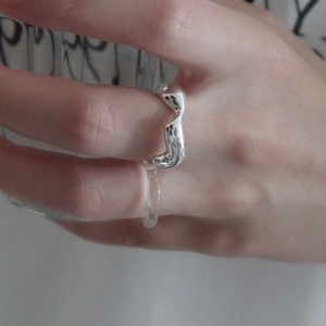 Minimalist 925 sterling silver irregular wave ring for women on model holding a glass