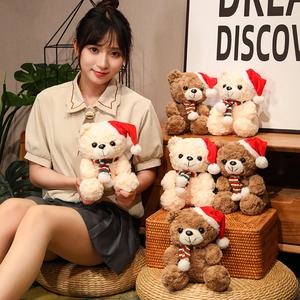 Group of Christmas teddy bears with red hats and striped scarves for holiday gifts