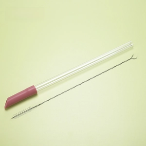 Close-up of a 1.2cm Tritan telescopic straw in smoky pink with a cleaning brush set