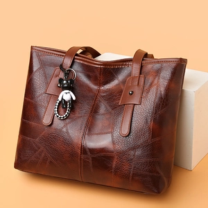 Brown faux leather tote bag with unique texture and cute bear charm pendant