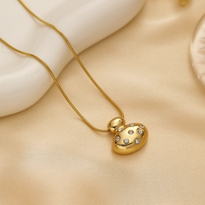 Elegant gold oval pendant necklace with sparkling zircons on a delicate snake chain