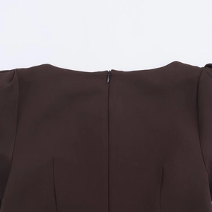Close-up of dark brown dress back featuring a neat invisible zipper and sleek boat neckline