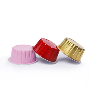 Set of three colorful aluminum foil pudding cups in pink, red, and gold finishes