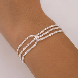 Minimalist silver woven layered necklace with three interlocking chains for a textured look