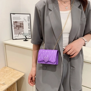 Purple mini silicone crossbody bag for girls with heart decor and gold chain strap
