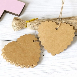 Detail of 6cm heart kraft paper gift tags with scalloped edges and natural jute twine
