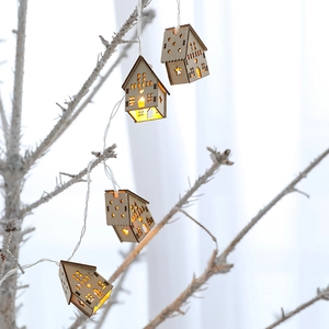 Wooden house string lights with cutout stars and hearts for Christmas decoration