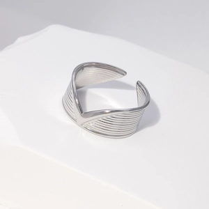 Detailed view of silver wide V-shaped adjustable ring with horizontal textures