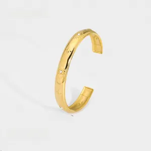 Detail of gold hollow heart bangle with star relief and white zircon inlay, 0.93cm wide