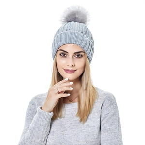 Close-up of grey ribbed knit beanie with a large matching pom-pom and warm texture
