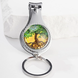 Detail of tree of life pattern nail clipper keychain on natural white stone background