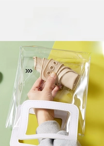 Close-up of a foldable soft silicone baby bib packed in a clear PVC travel pouch