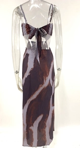 Detail of the tie-dye maxi skirt set showing the back lace-up crop top and flowing hem